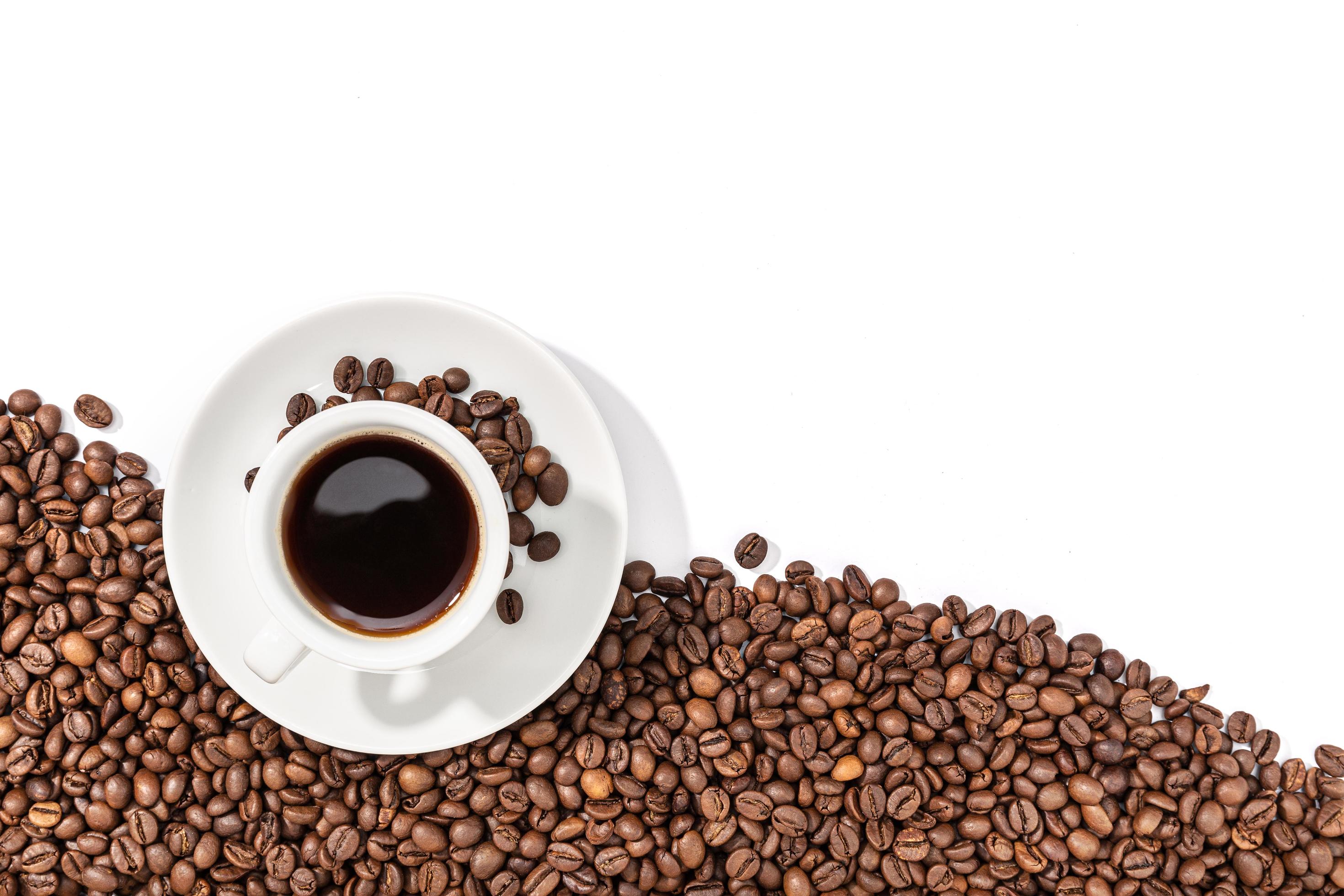 Cup of espresso coffee and roasted beans on white background 1377296