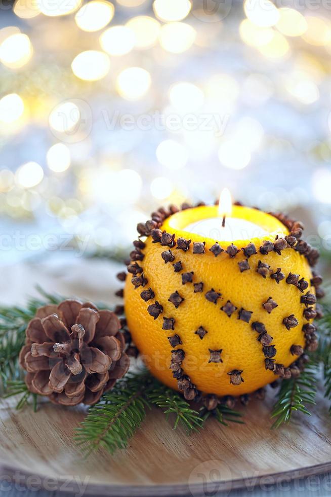 Aromatic Christmas orange with candle photo