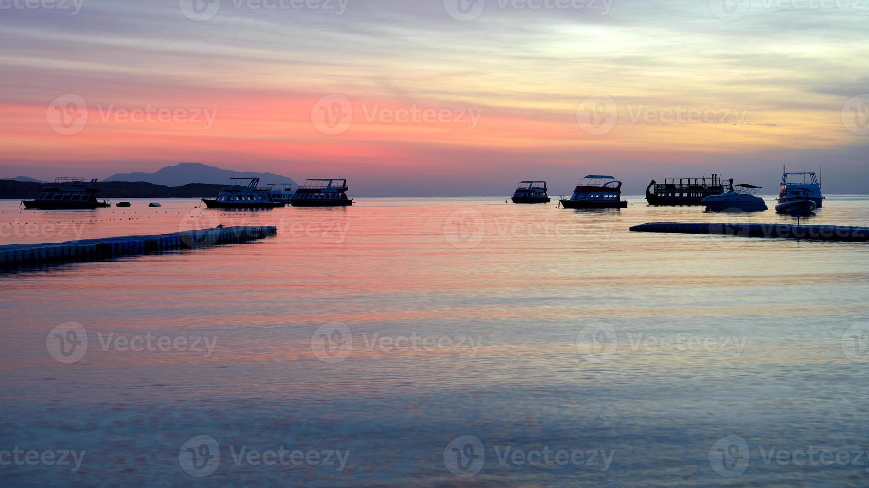 Sunrise at Naama Bay, Red Sea and motor yachts photo