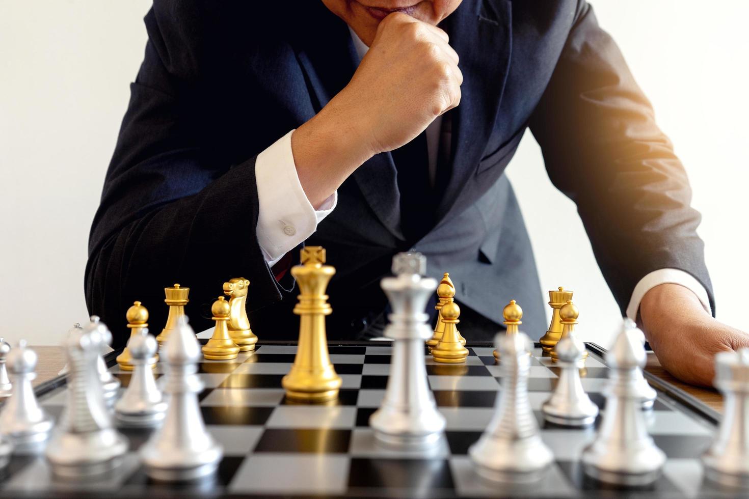 Chess game on chess board behind business man background. Business concept  to present financial information and marketing strategy analysis. Investmen  Stock Photo - Alamy