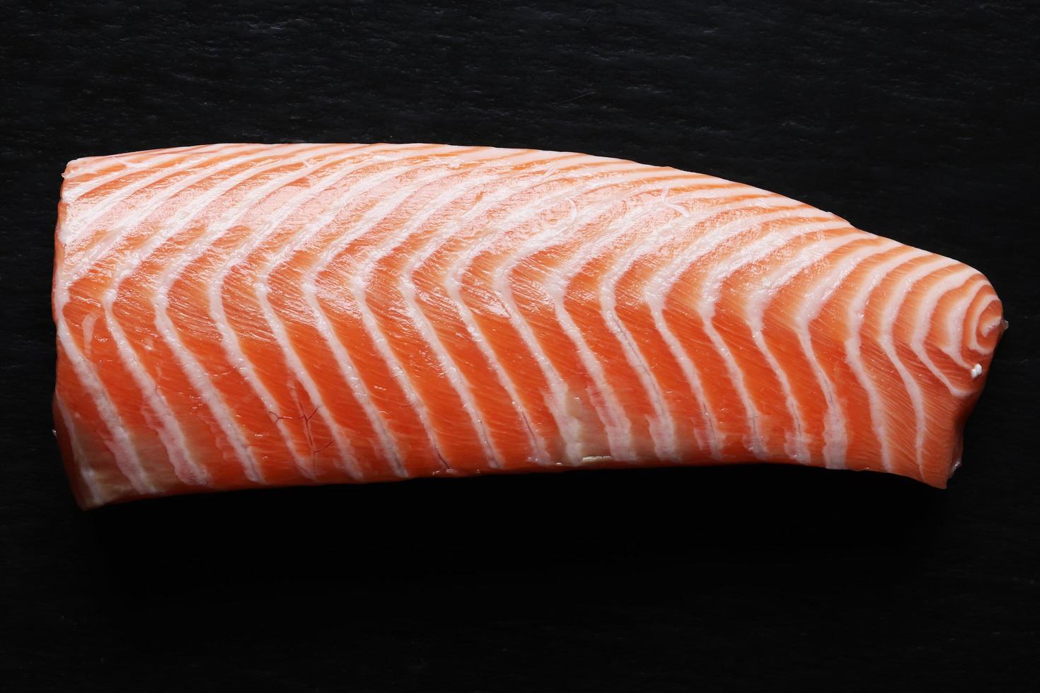 Peeled salmon on black background photo