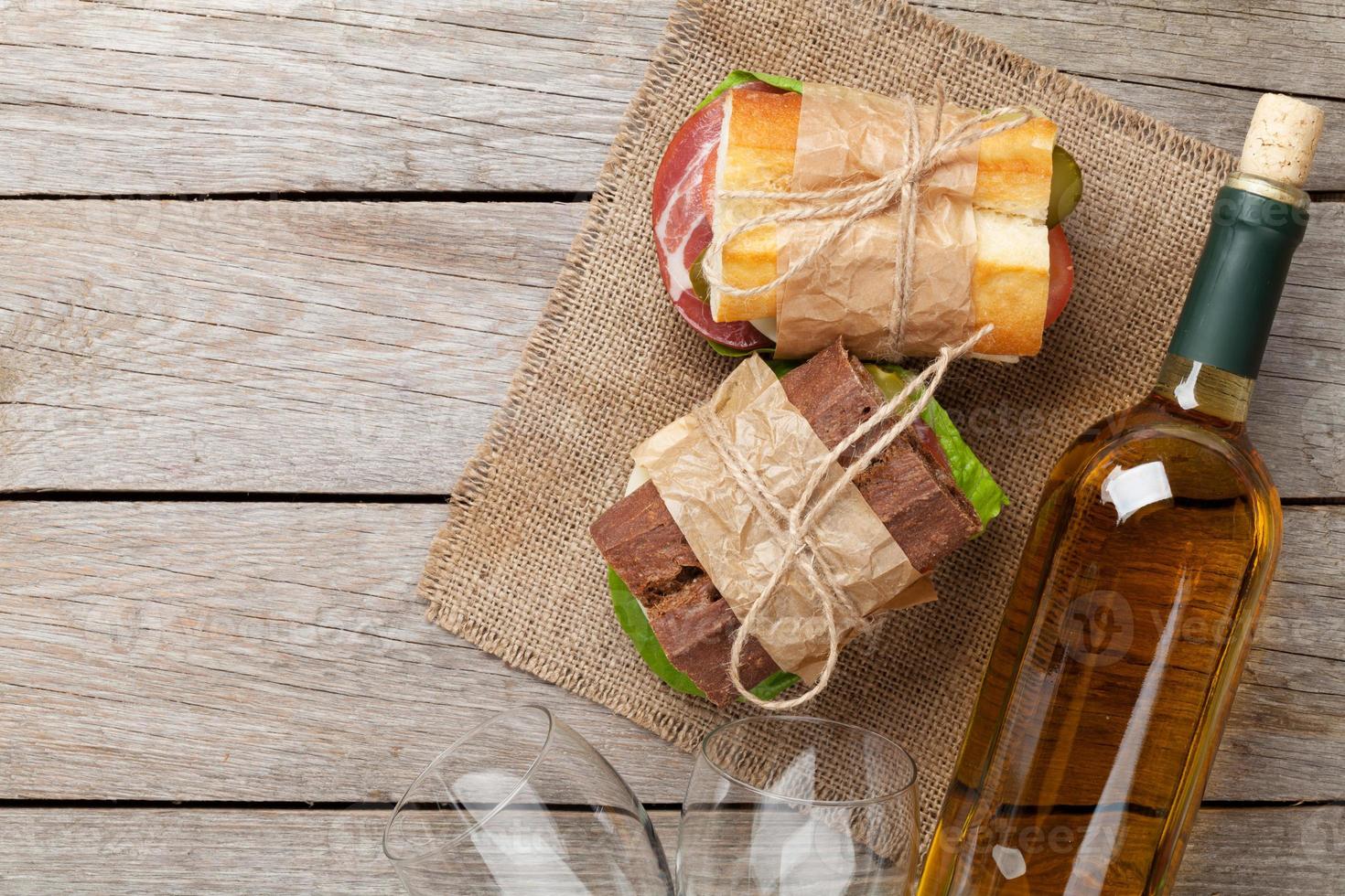 Two sandwiches and white wine photo