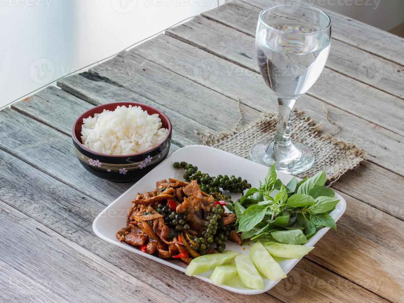 Stir-fried with spicy, thai food, rice in cup and water photo