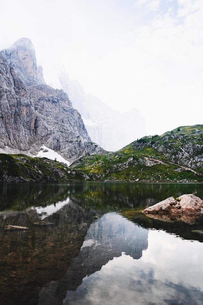 Calm body of water near mountain photo