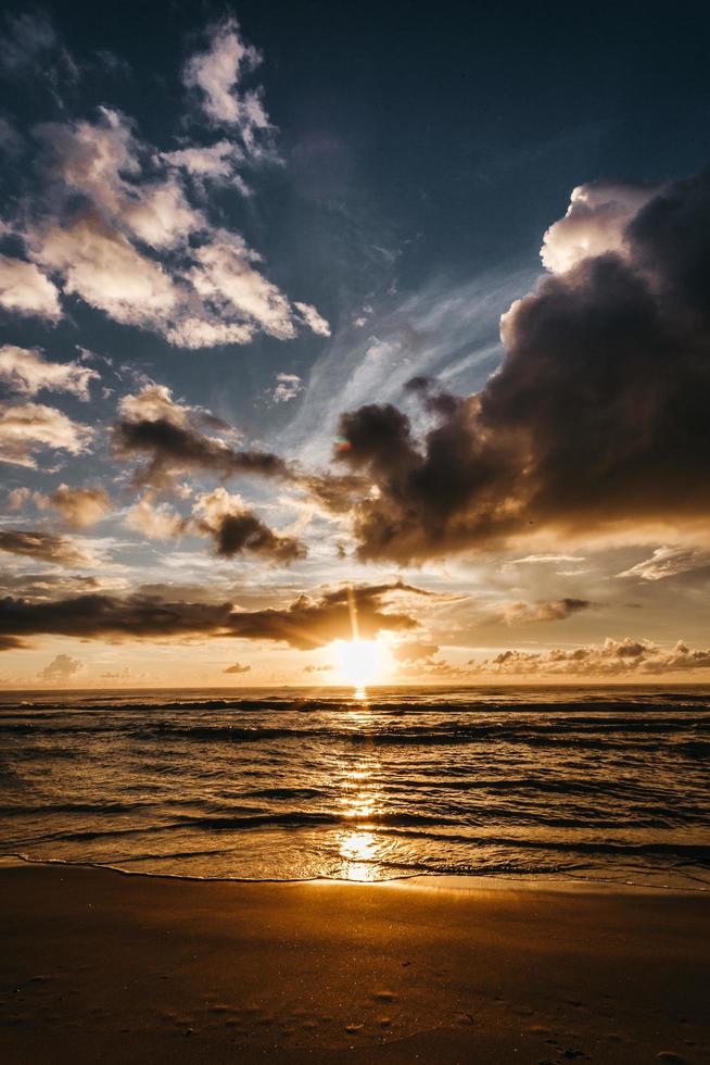 Sunset sky over waving sea photo