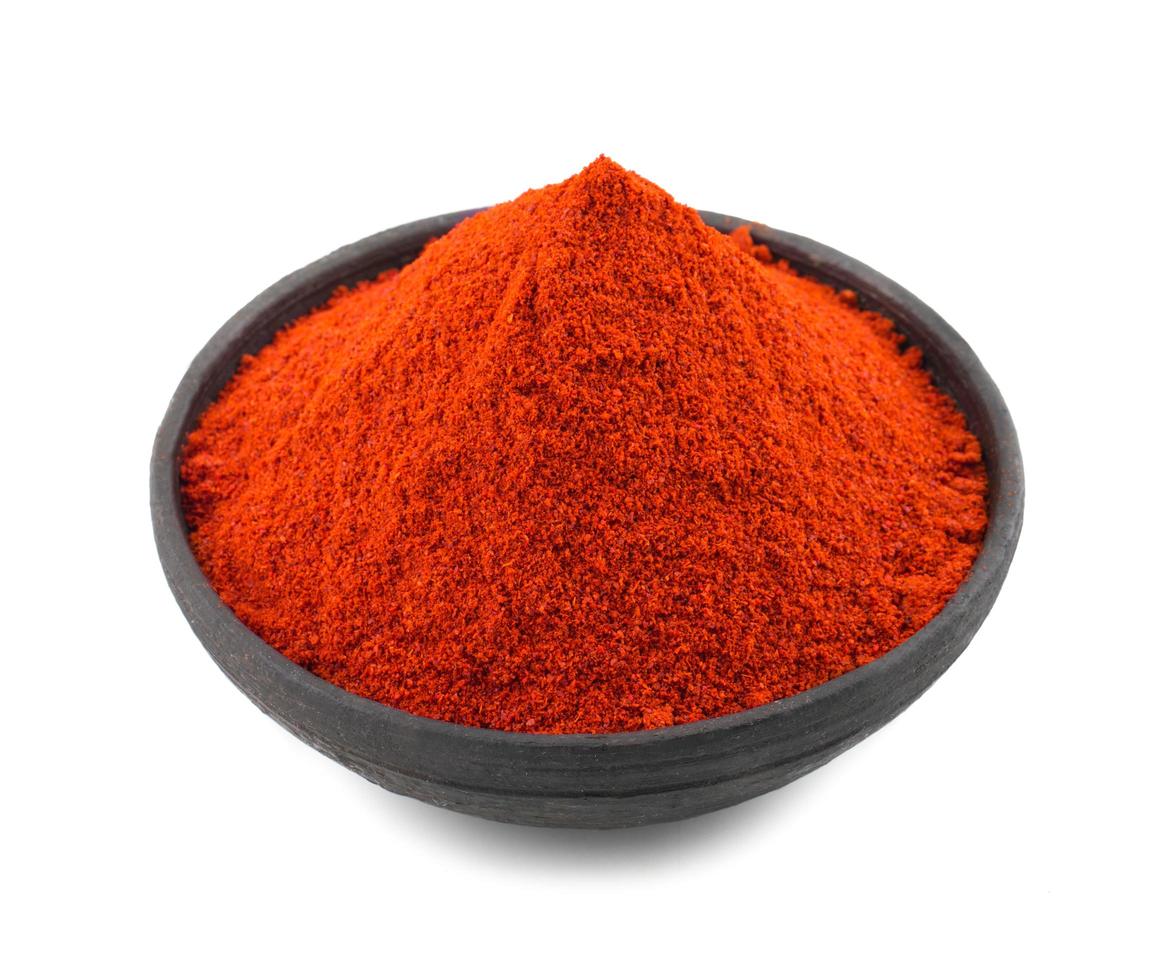 Red chili pepper powder on white background photo