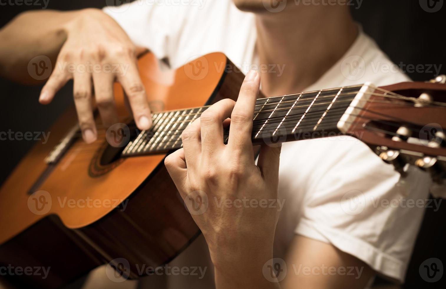 musician plays acoustic, classical guitar photo