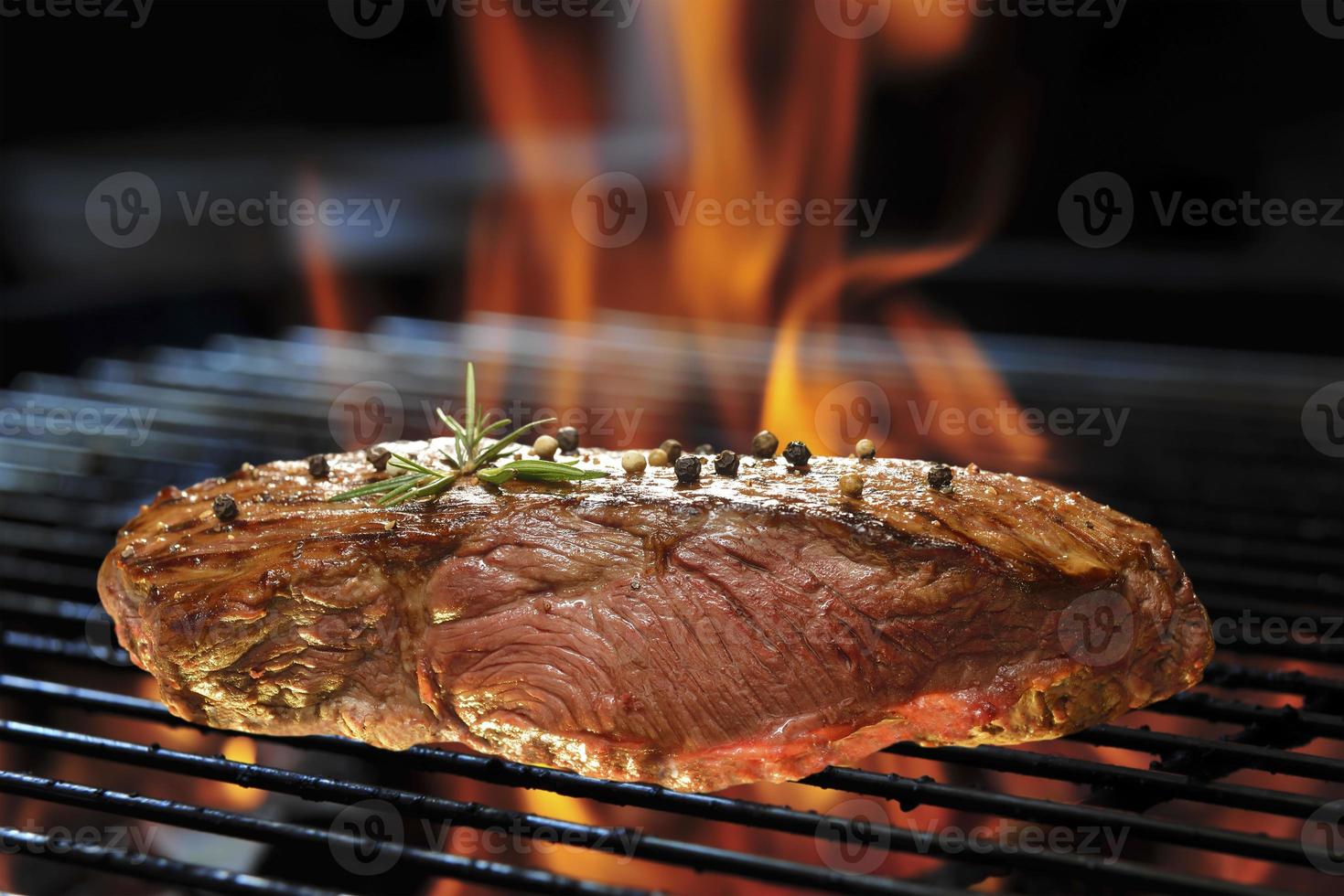 Grilled beef steak on the flaming grill 1398955 Stock Photo at Vecteezy