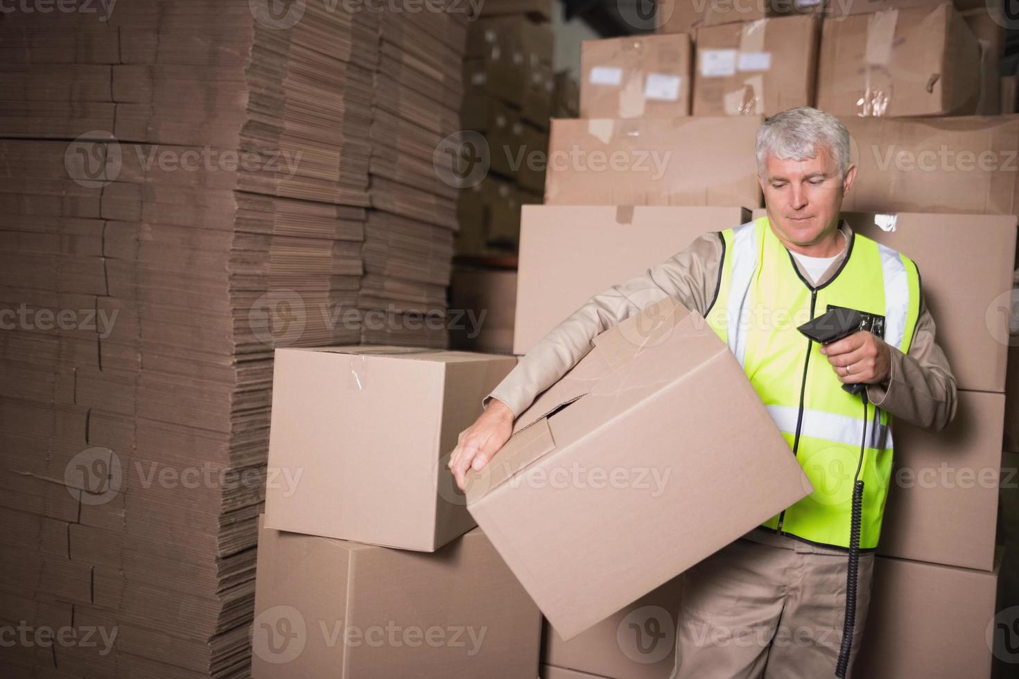 Worker scanning package in warehouse 1407155 Stock Photo at Vecteezy