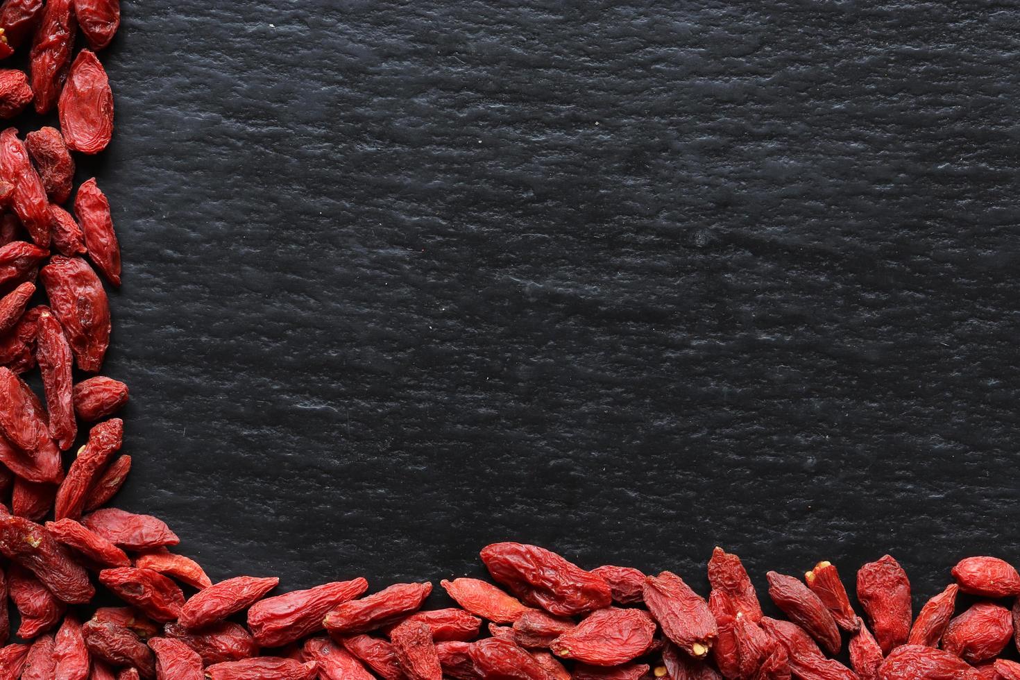 Goji berries on slate background photo