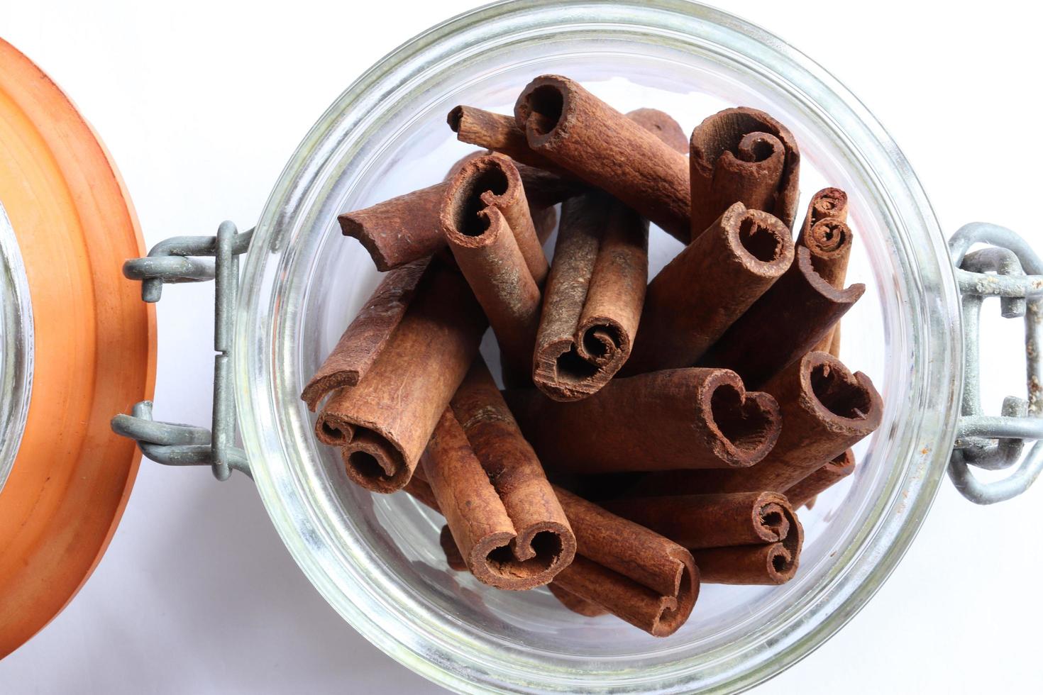 A bundle of cinnamon sticks in a glass jar photo