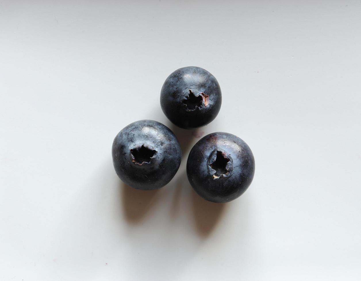 Three blueberries isolated on white photo
