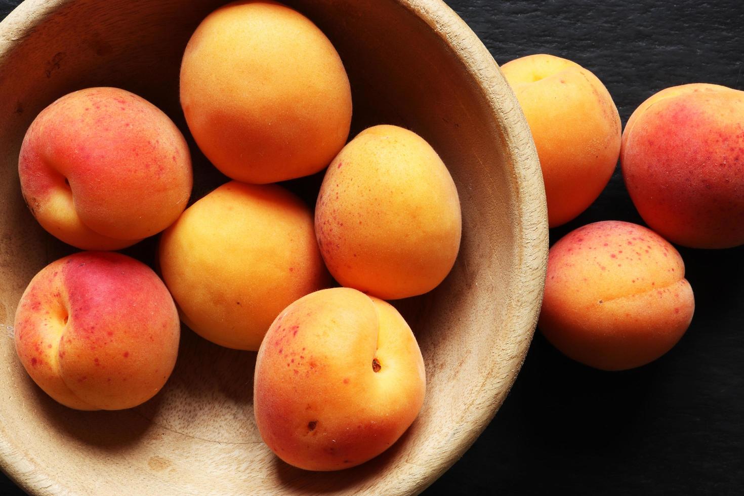 Apricots in a wooden bowl photo