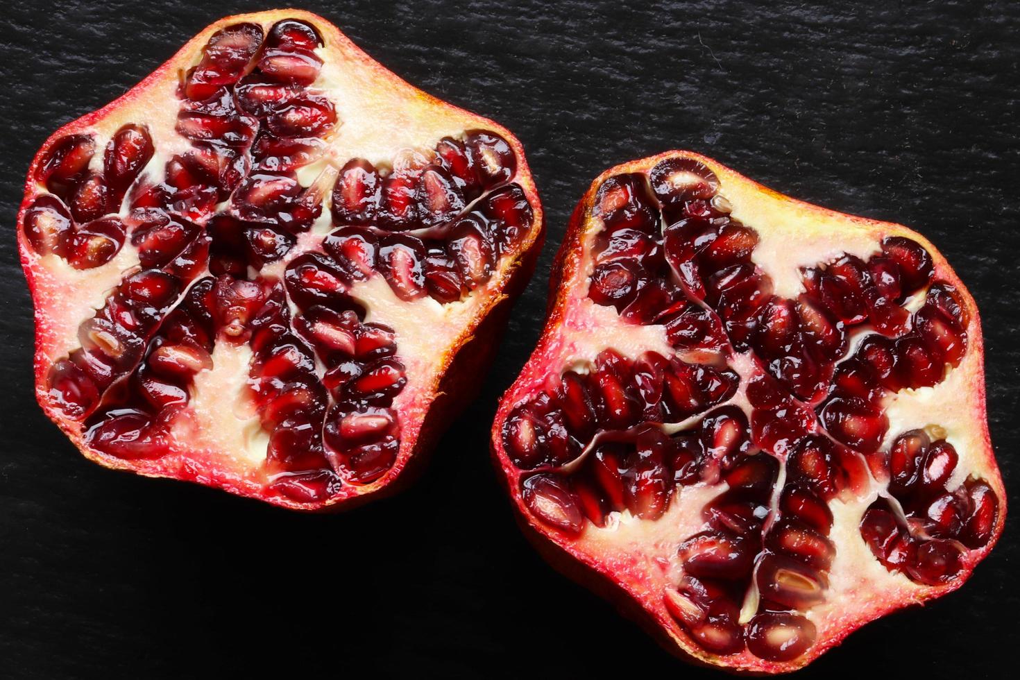 An organic pomegranate cut in half photo