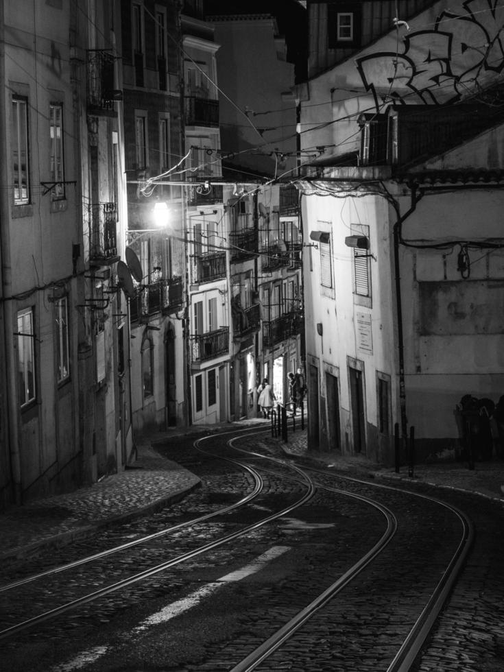 Grayscale photo of alley way in Lisbon