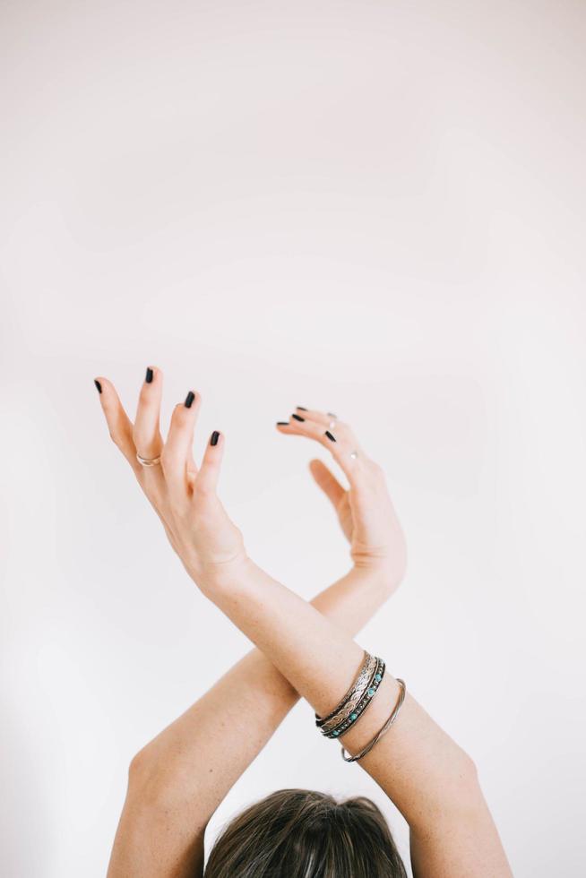 Woman raising both hands photo