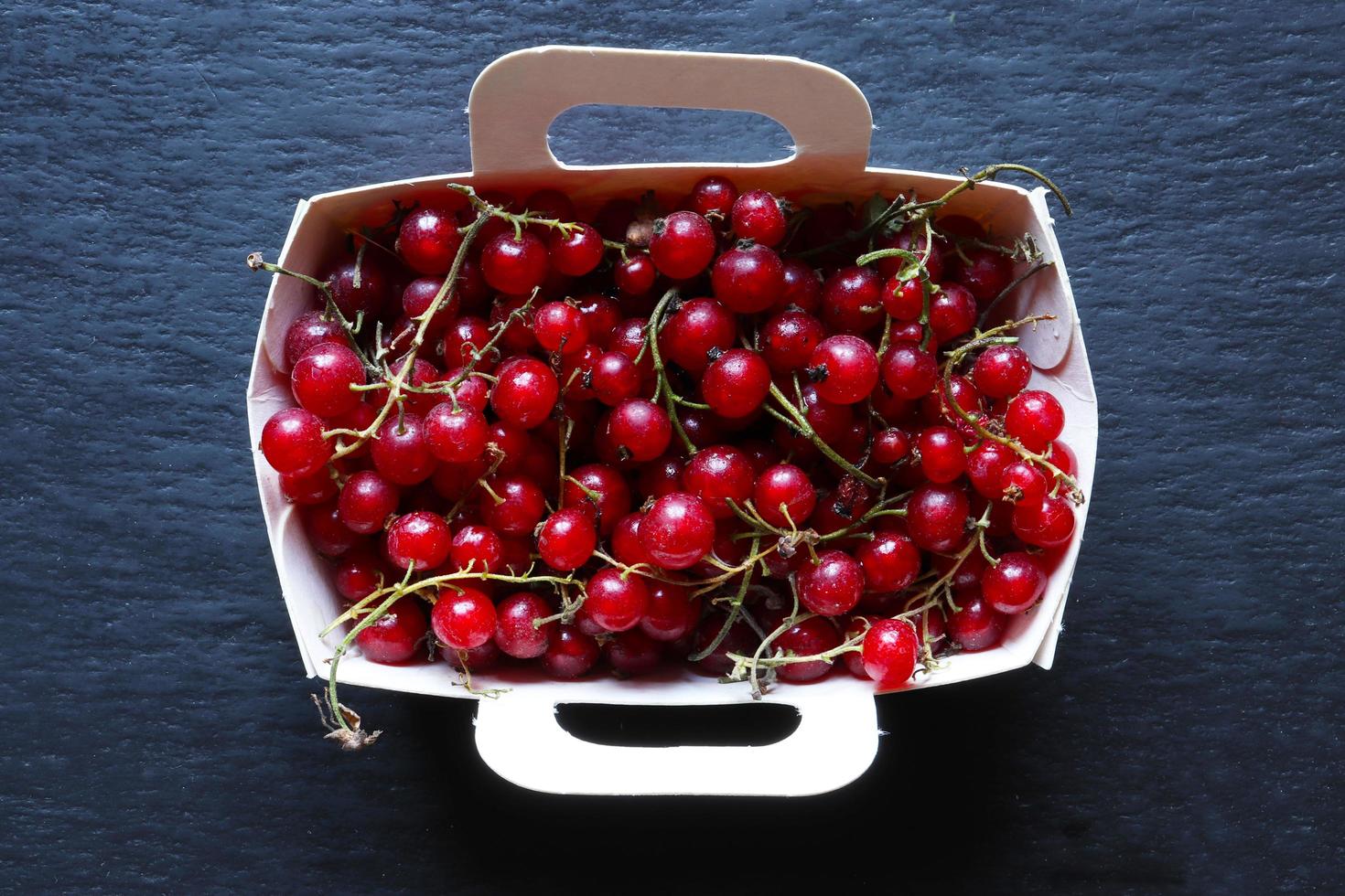 Red currants in a paper tray photo