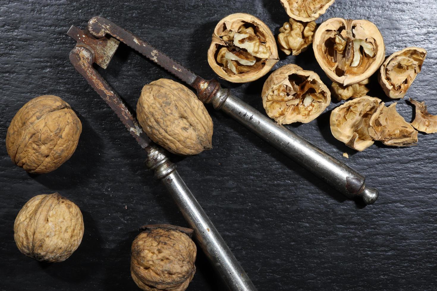 Nutcracker and walnuts on a slate background photo