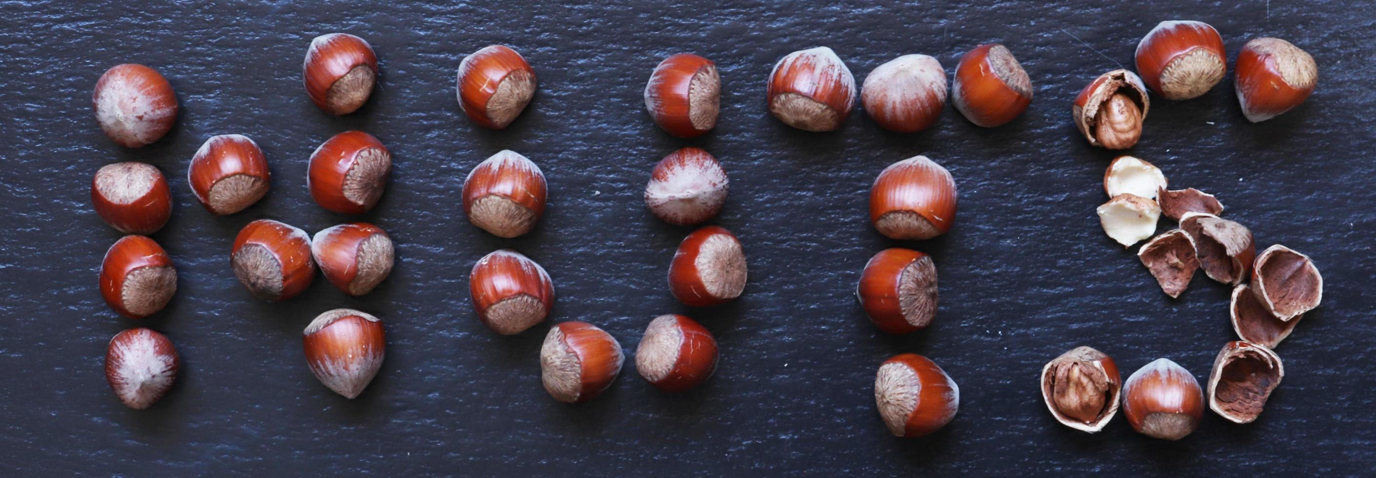 Hazelnuts arranged in the shape of the word nuts photo
