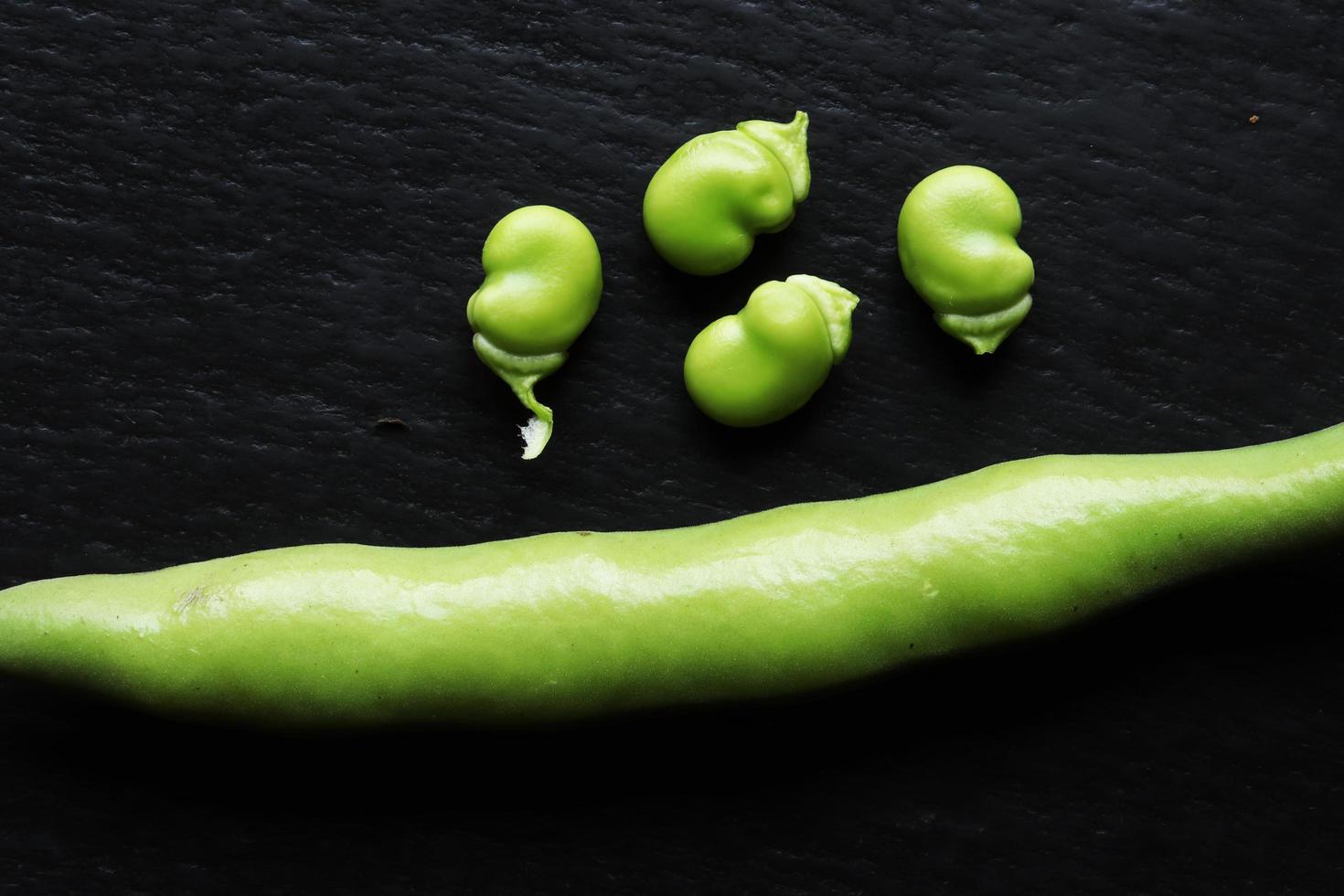 Bean pods isolated on slate background photo