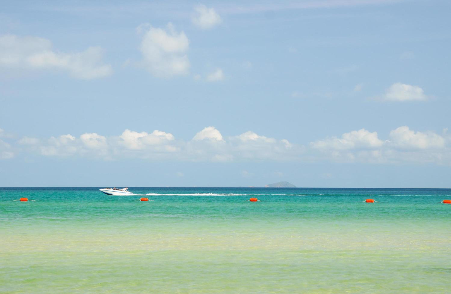 Speedboat sailing along the beach photo