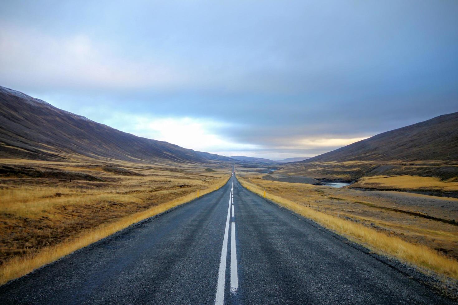 Road running through a hilly landscape photo