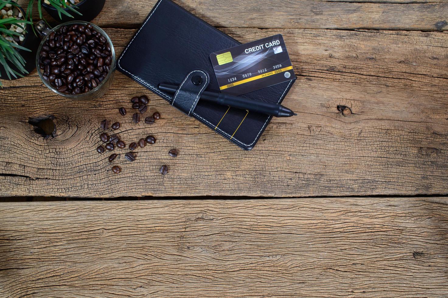 Credit card, notebook and coffee beans photo