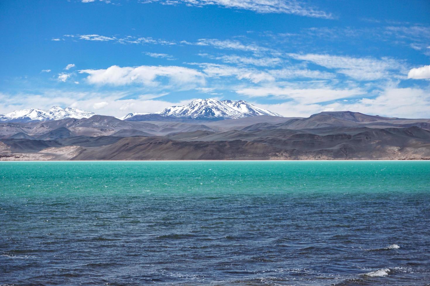 Clear blue sea near mountains photo