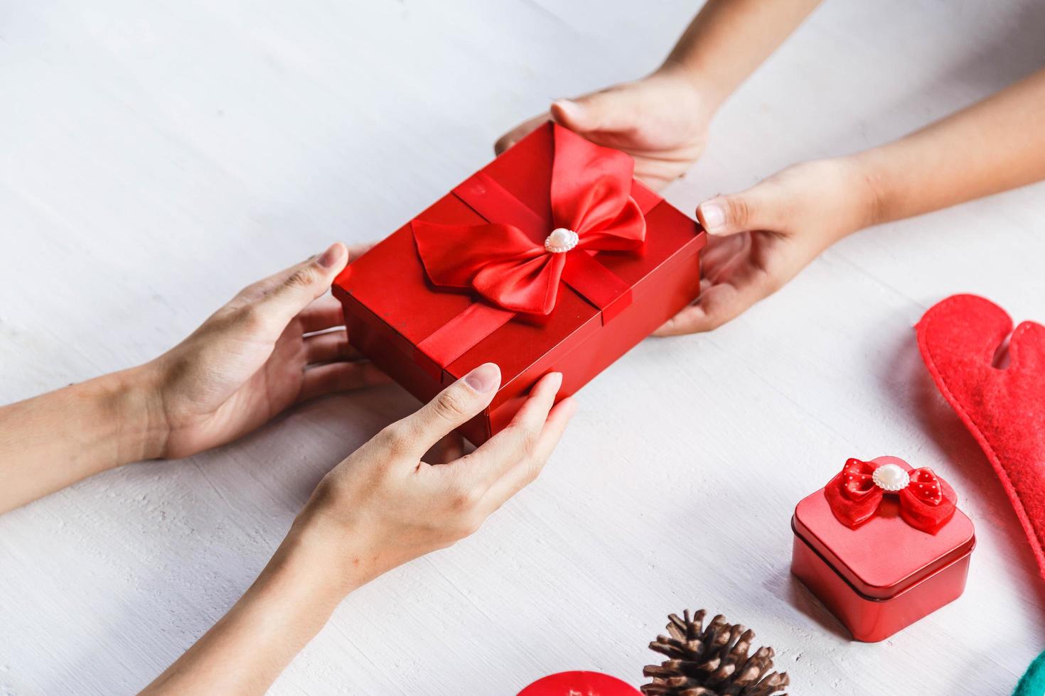 Two people holding a gift box photo
