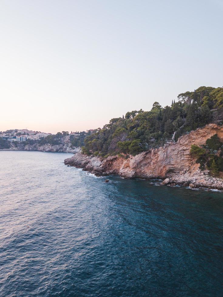 Blue ocean near a cliff photo