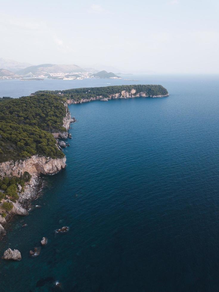 Aerial view of green cliff near ocean photo