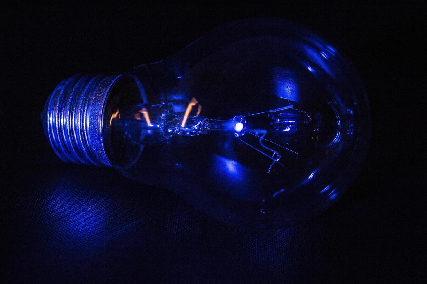 Light bulb illuminated by a blue light photo