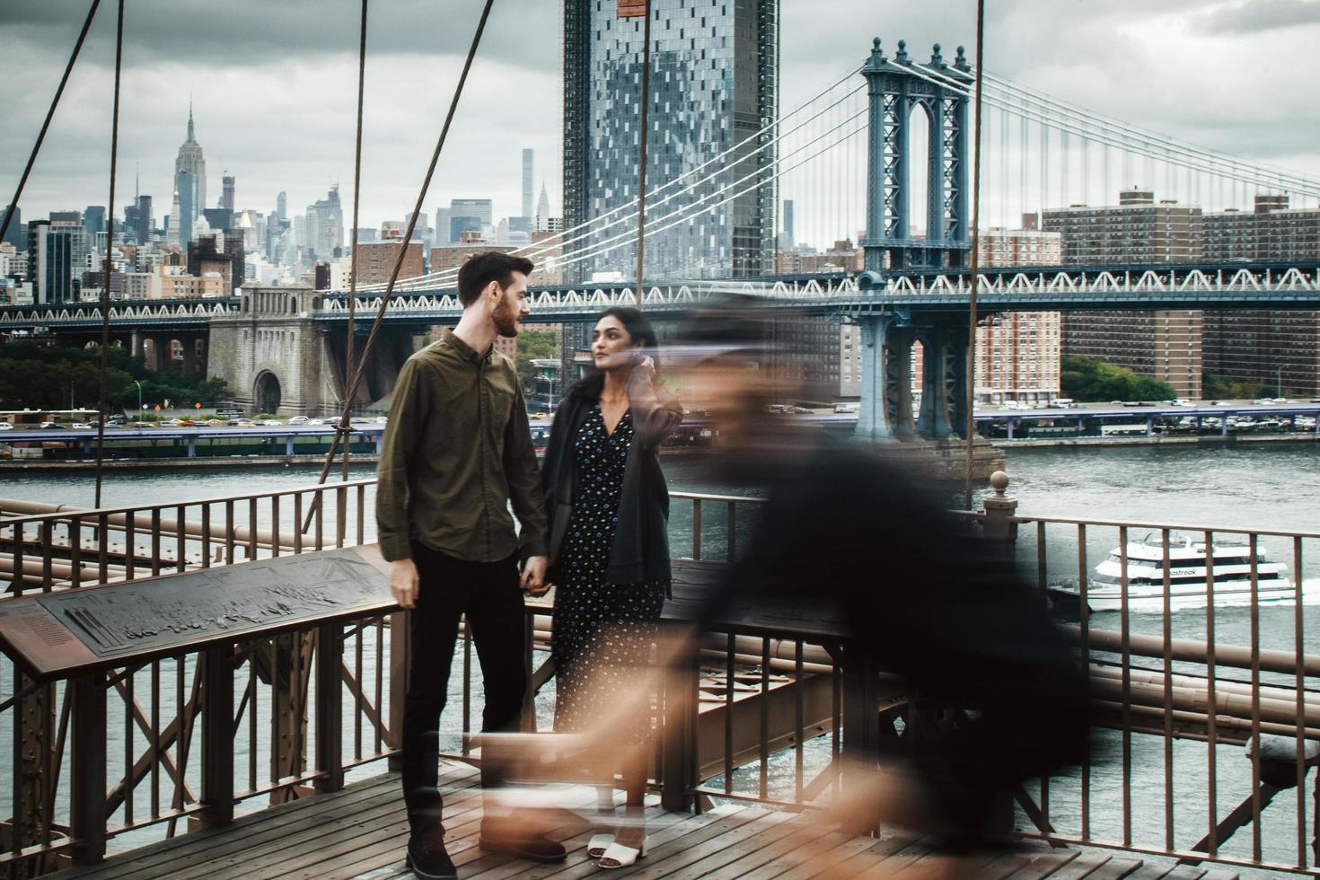 Attractive couple embraces in busy city waterfront photo