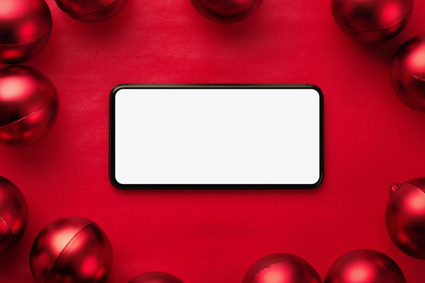 Smartphone mockup surrounded by red baubles photo