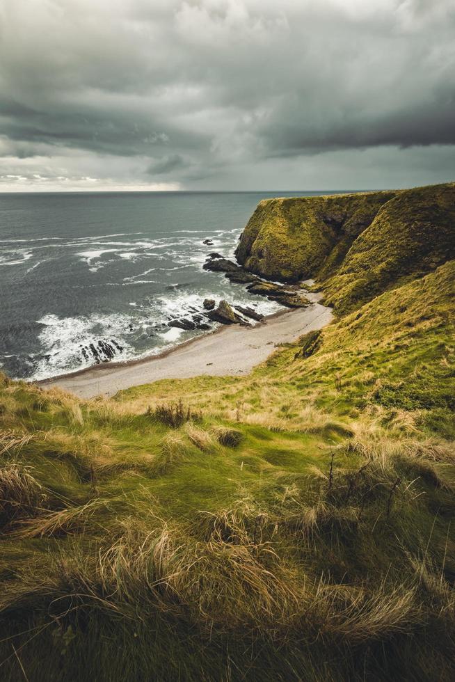 Mountain range and seashore during daytime photo