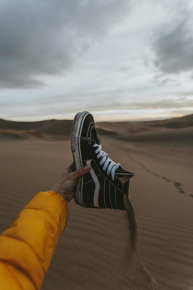 Pouring sand out of high tops photo