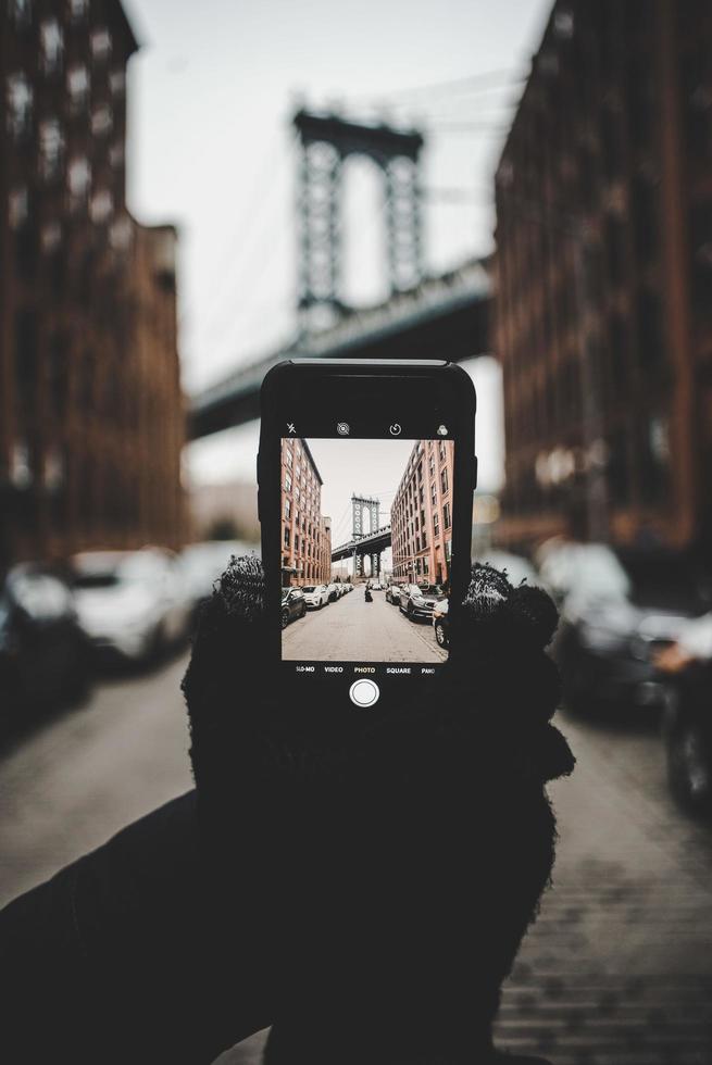 Brooklyn, United States, 2020 - Person taking photo of the Brooklyn bridge