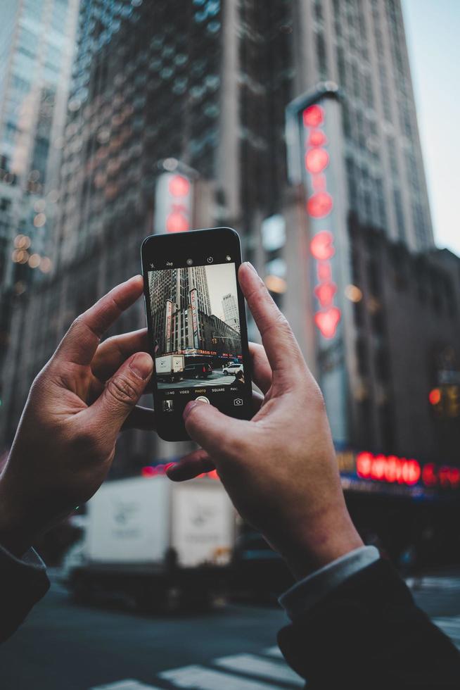 Radio City Music Hall, New York City, United States, 2020 - Person taking photo of building