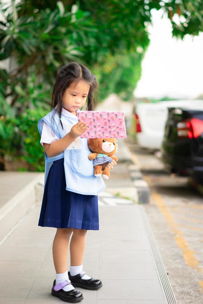 Little Asian girl in Thai school uniform photo