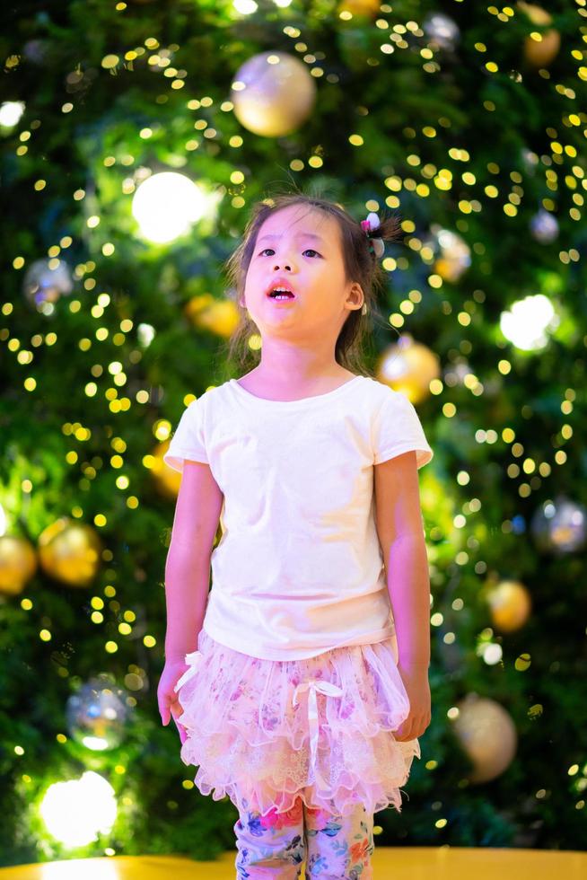 Little Asian girl and bokeh background on Christmas day photo