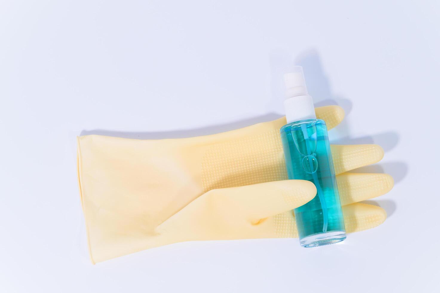 Sanitary glove and alcohol gel on white background photo