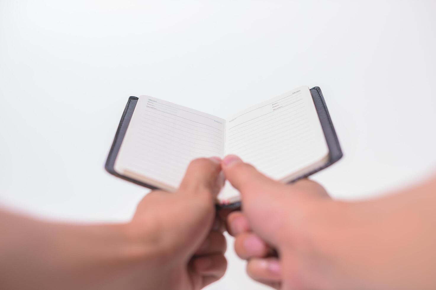 Hand holding a notebook photo