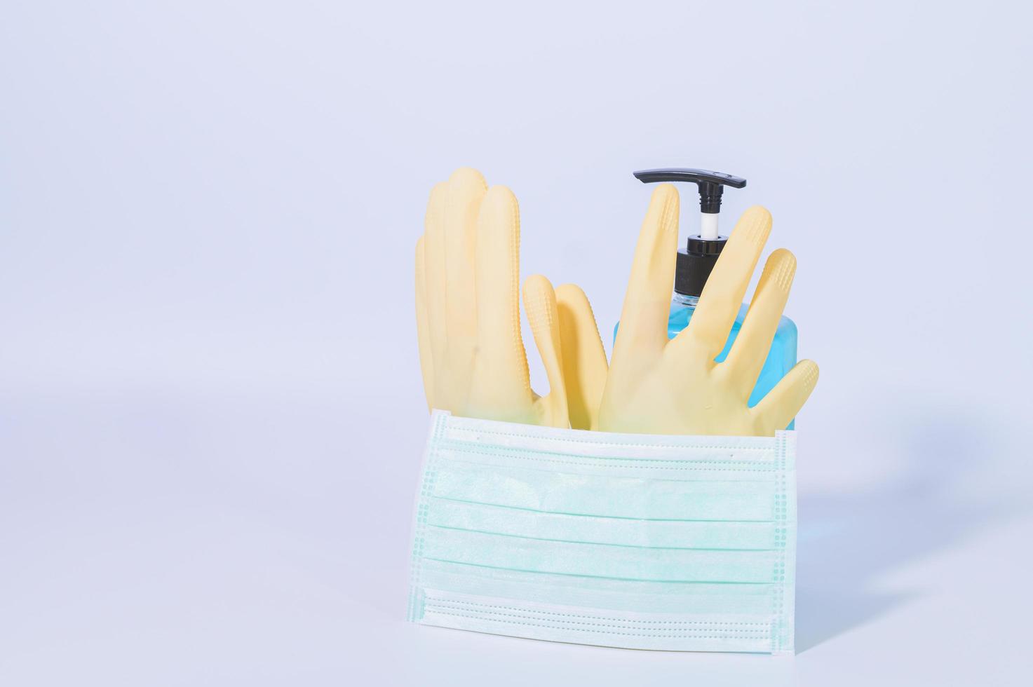 Latex gloves, alcohol gel and protective mask photo