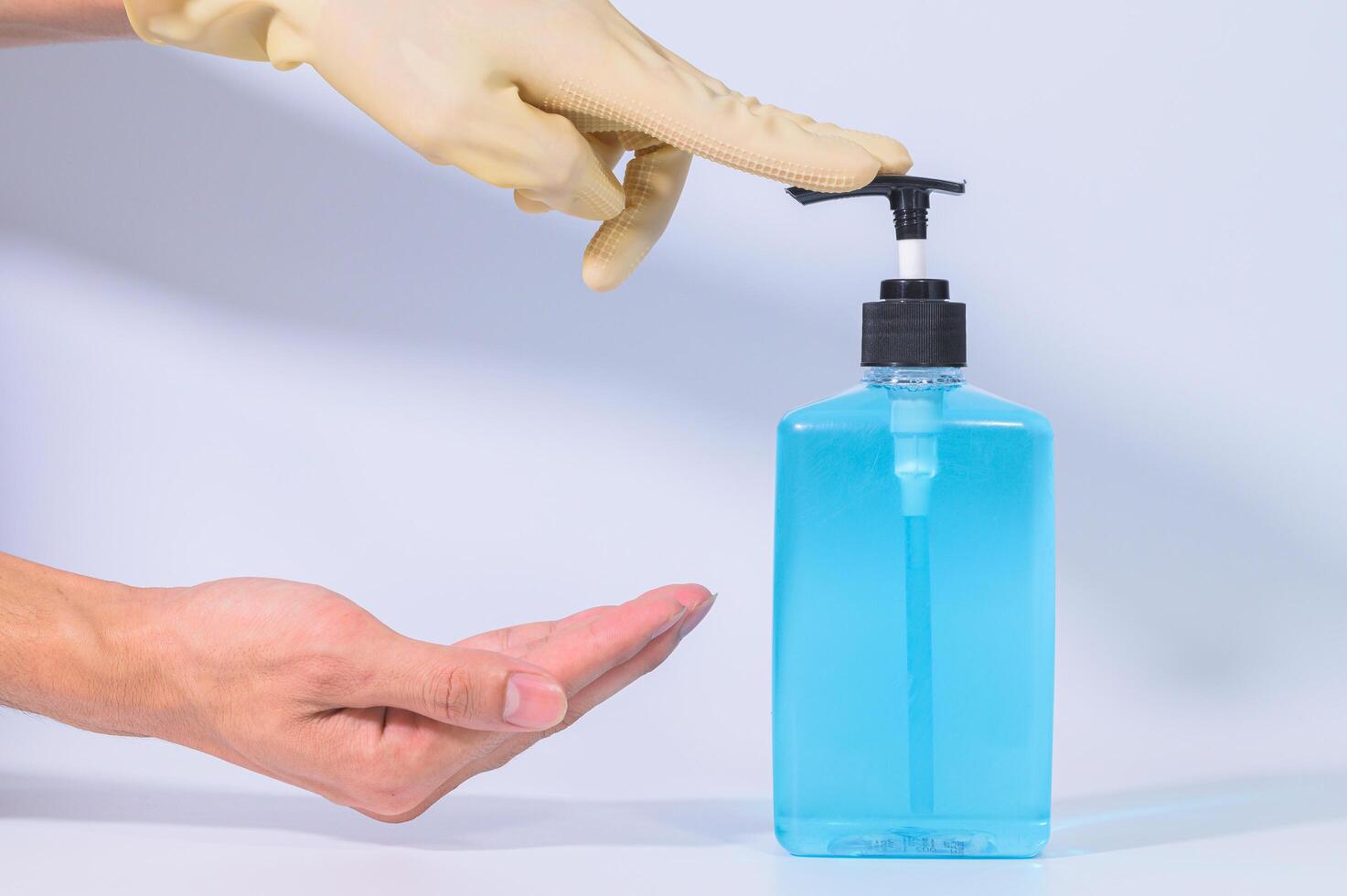 Cleaning hands with alcohol gel photo