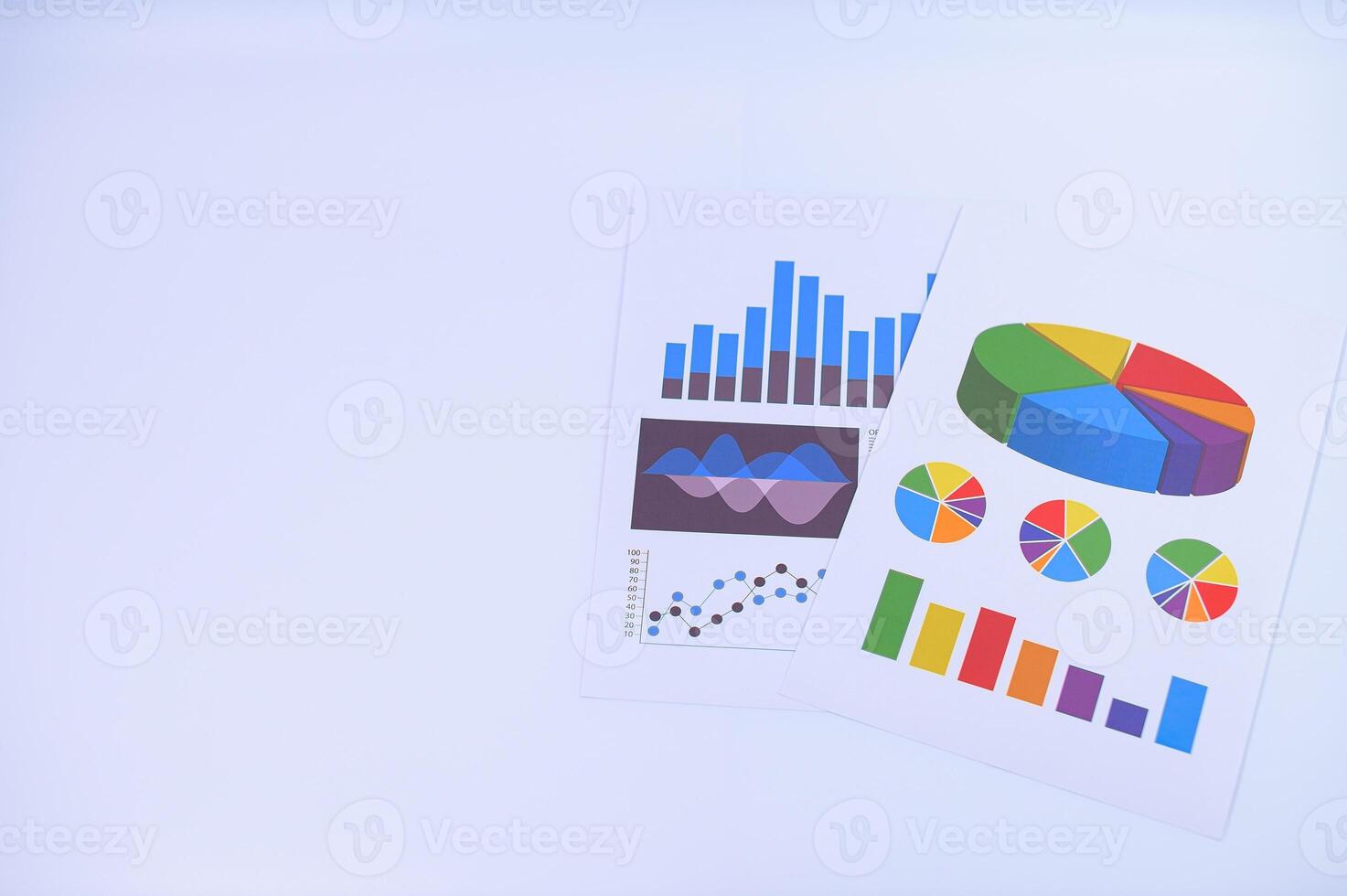 A white background with a paper with graphs and charts photo
