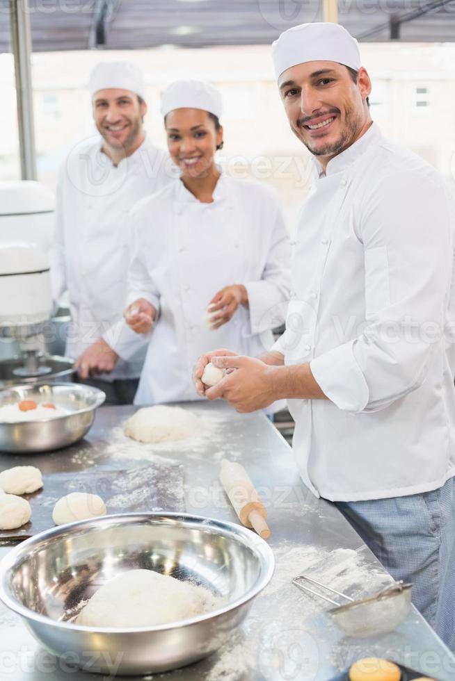Team of bakers working at counter photo