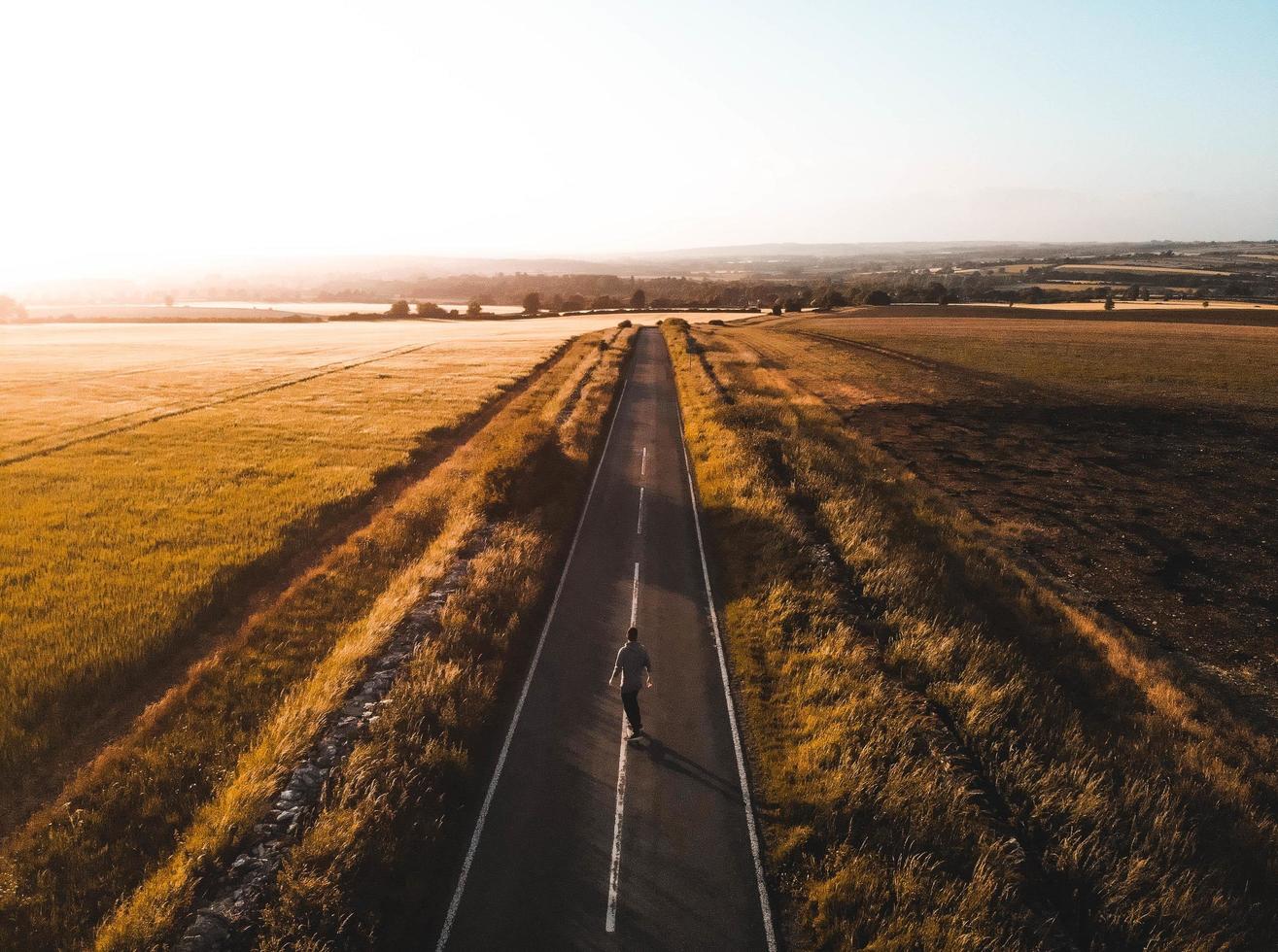 Aerial view of a person on a skateboard at sunset photo