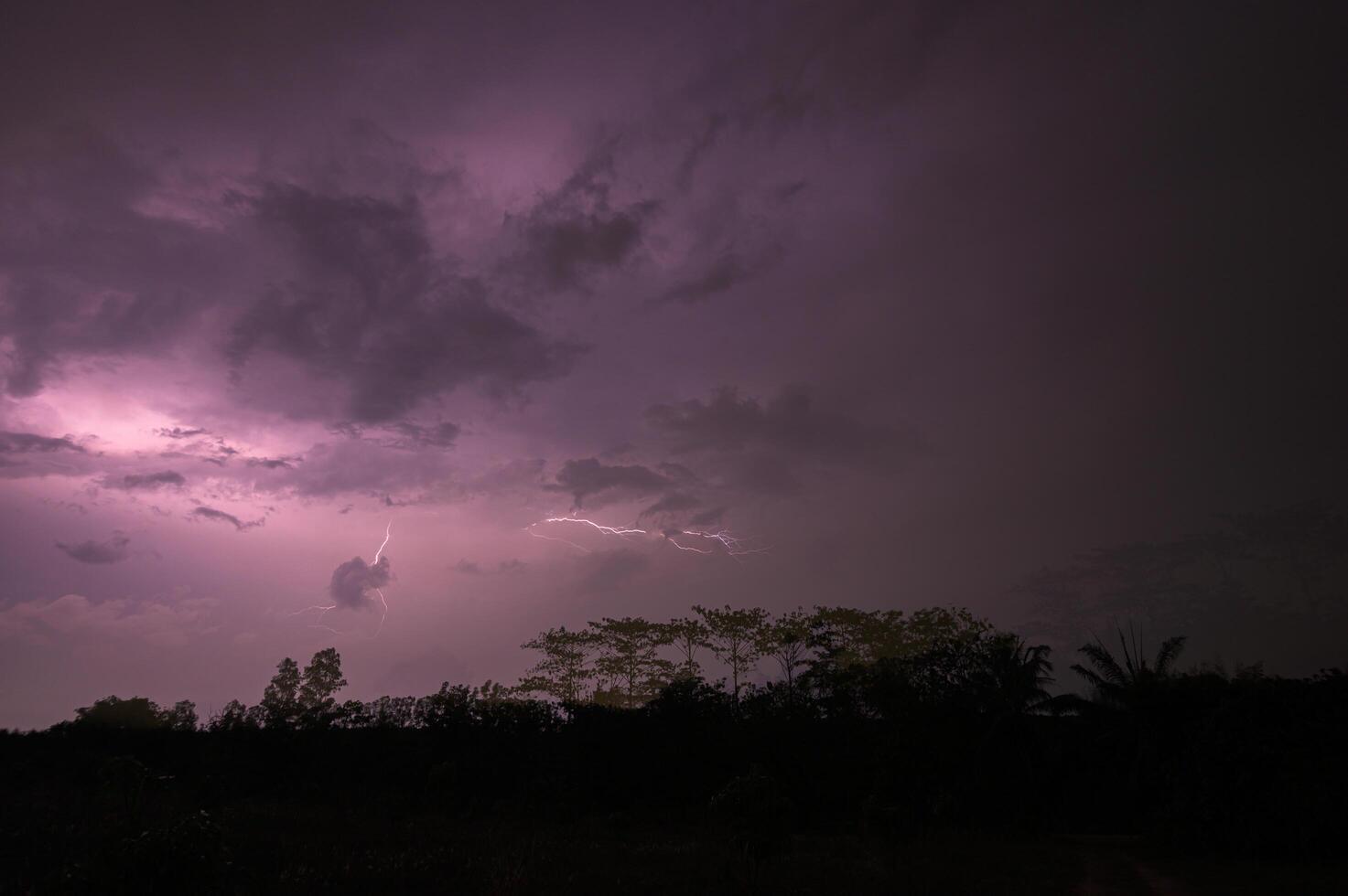 Lightning in the sky at night photo