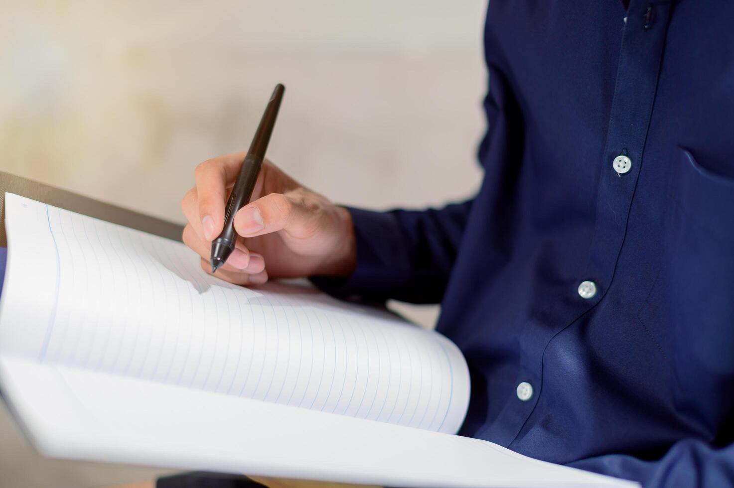 Businessman writing notes photo