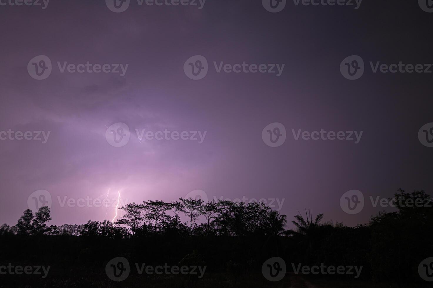 Lightning in the sky over a field photo
